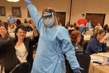 Shift coach program participant donning PPE